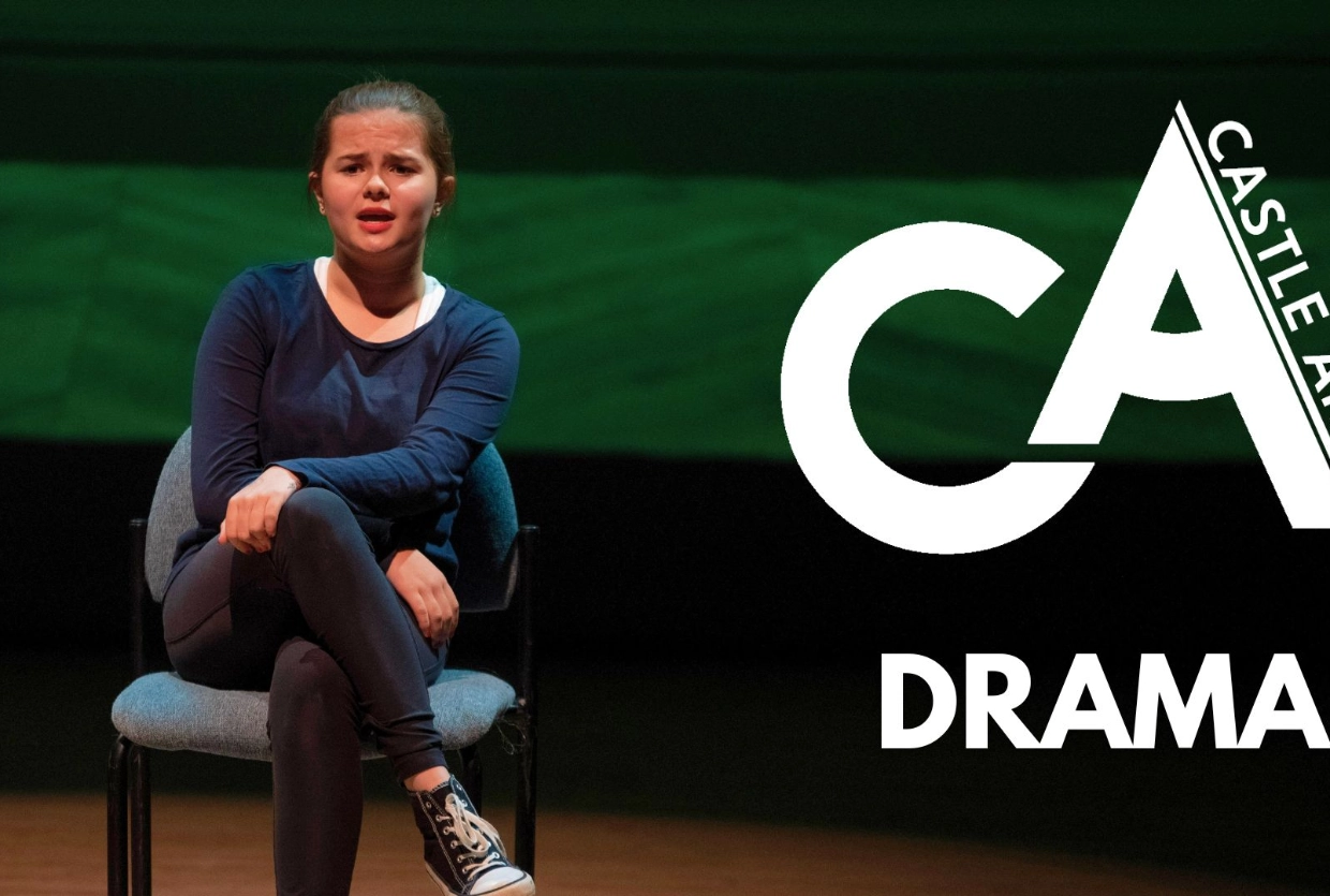 girl sat on a chair on a stage