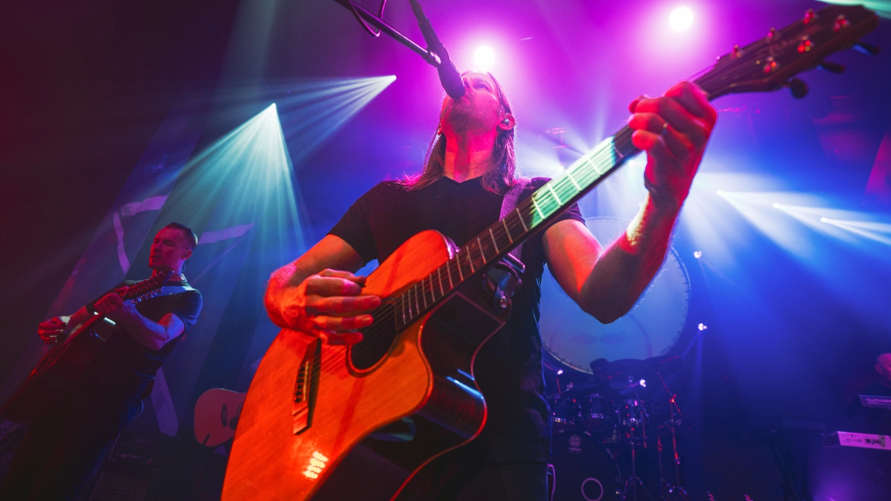 Person playing acoustic guitar