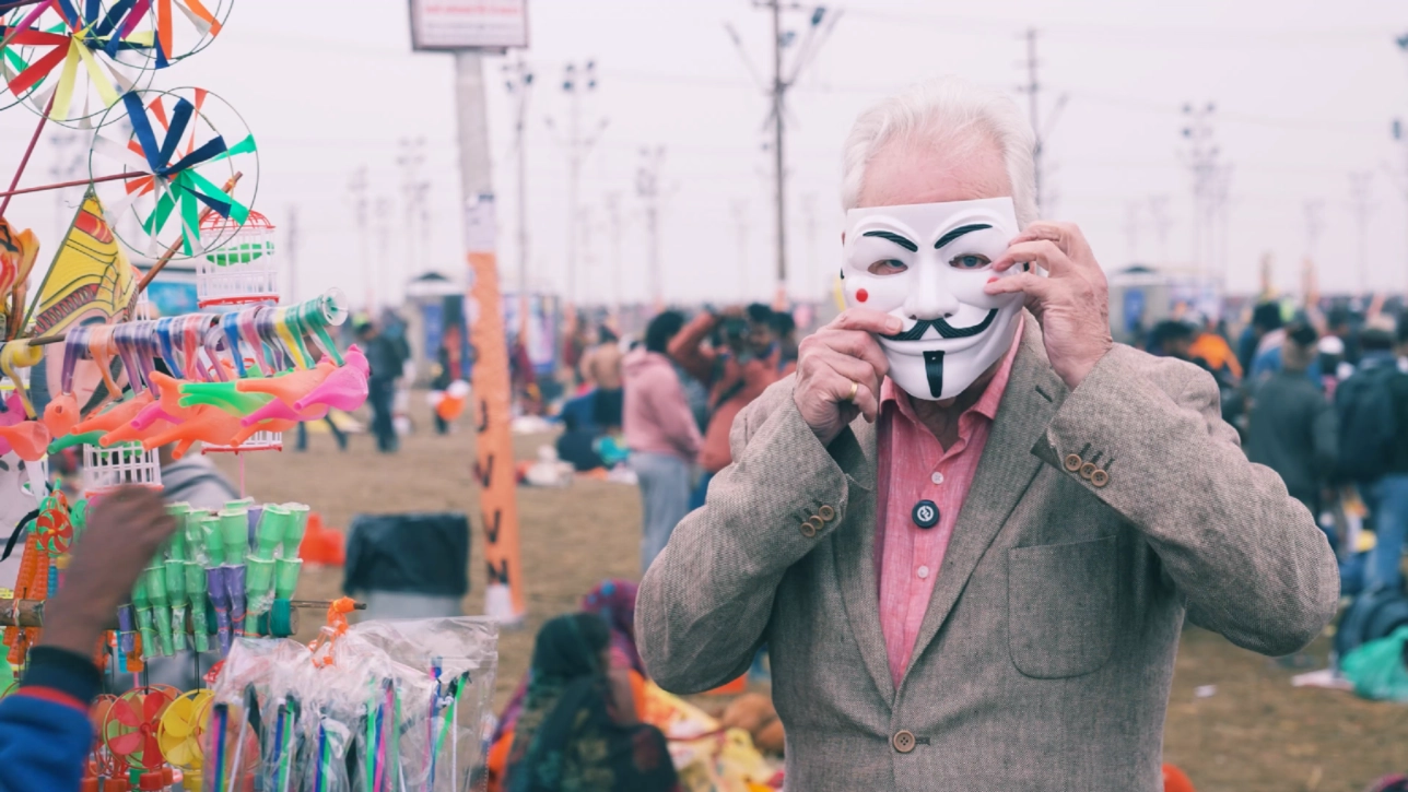 man holding up mask against face