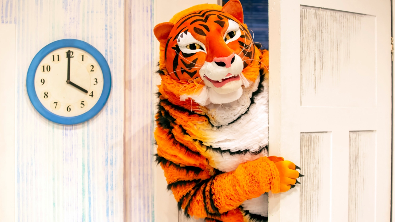 Person in Tiger costume looking through door