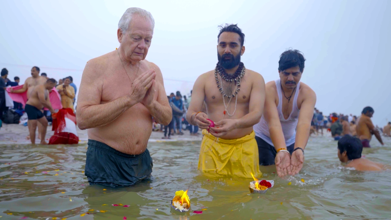 group of men conducting rituals in river
