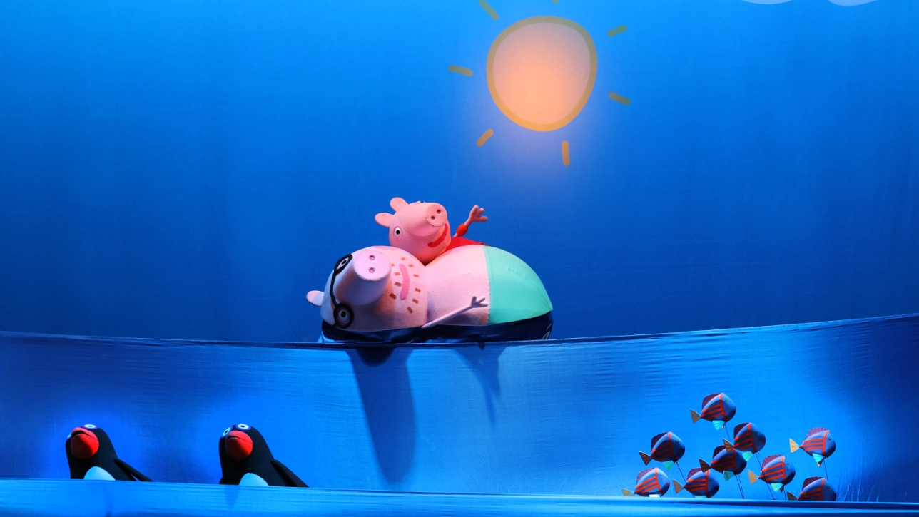 Image of Peppa Pig and a sun on stage
