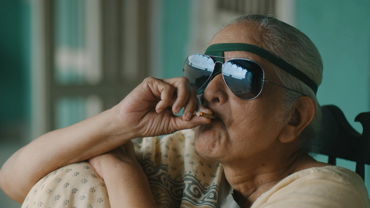 Older Indian women with sunglasses smoking