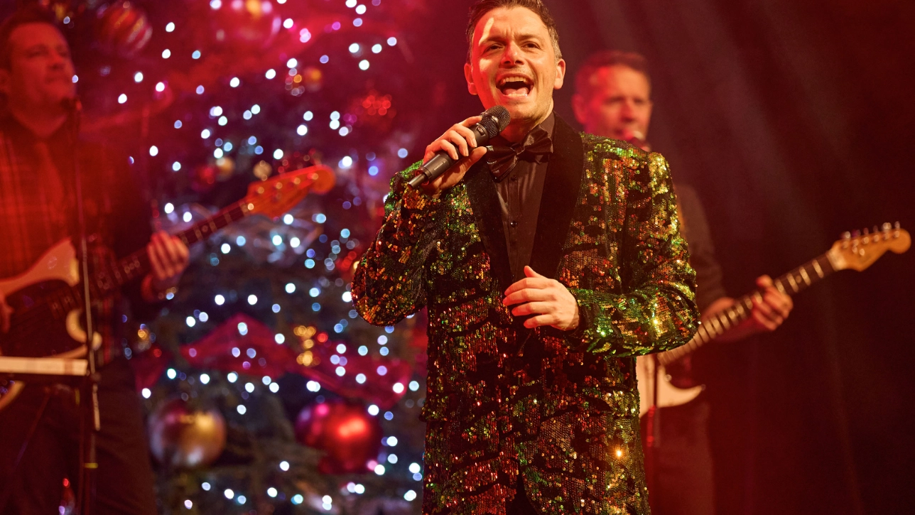 Person in green jacket singing