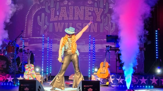 Woman on stage with guitars 
